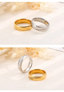 Detailed macro view of two-tone gold and silver stainless steel rings with zircon inlay