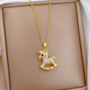 Detail shot of a luxury gold-plated unicorn pendant necklace with sparkling crystal inlay