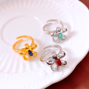 Macro shot of vintage style floral rings with colorful stones on a ceramic plate