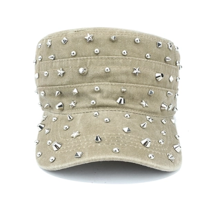 Close-up of khaki washed canvas army cap featuring silver punk rivets and star studs