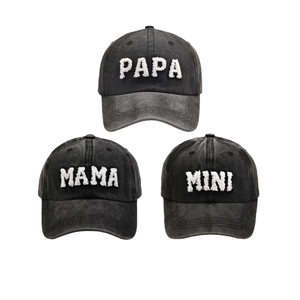 Detailed view of family matching baseball caps with white PAPA MAMA MINI towel embroidery