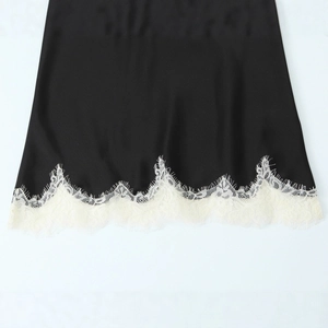 Elegant black satin top featuring delicate white eyelash lace trim on the hemline
