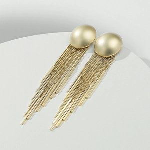 Detailed close-up of elegant gold tassel earrings with sleek metallic chains and minimalist bars
