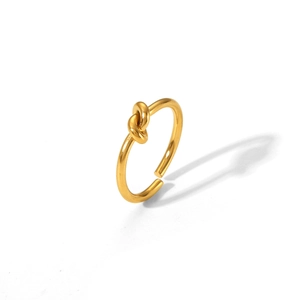 Close-up of a minimalist gold knotted ring made of durable stainless steel with open design