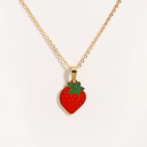Close-up of golden titanium steel necklace featuring a red enamel strawberry pendant