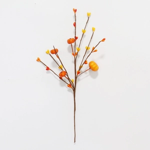 Detail view of artificial autumn branch with orange mini pumpkins and yellow berries