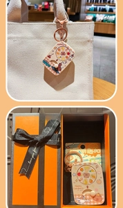 Cute spinning Capybara keychain on canvas bag and inside orange gift box set