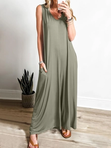 Detail view of olive green sleeveless jumpsuit showing functional side pockets and loose fit