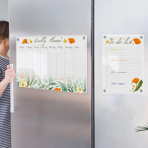 Weekly planner and to-do list acrylic board set mounted on a stainless steel fridge