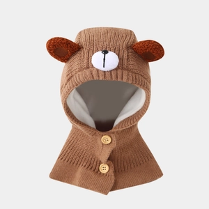 Detail of soft brown bear knit hood for kids with wooden buttons and warm fleece lining