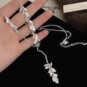 Minimalist silver leaf tassel necklace for women featuring fine metallic pendants