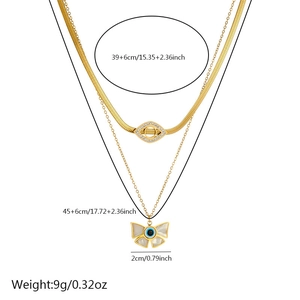 Detail of layered gold-plated stainless steel chain with eye and bow pendants and measurements