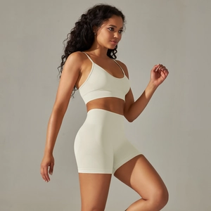 Detailed side view of cream seamless sports bra and high-waisted shorts yoga set