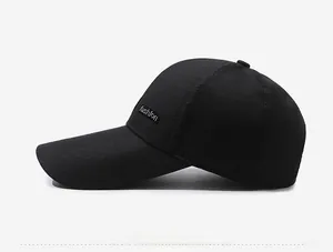Detail view of the black baseball cap showing the extended brim and fashion patch