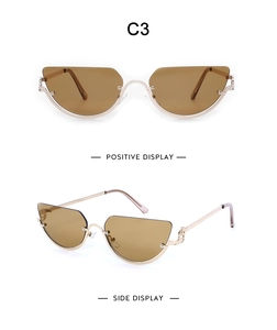 Detail view of retro semi-rimless cat eye sunglasses with gold metal frame and brown lenses