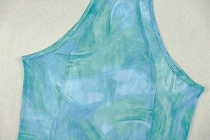 Detailed macro view of the blue and green tie-dye mesh fabric with fine reinforced seams