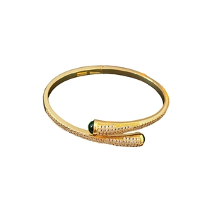 Gold-plated open bangle with white zircon pave and teardrop green gemstones