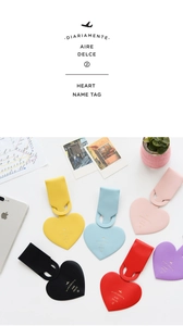 Macro shot of colorful heart-shaped faux leather luggage tags with fine PU texture