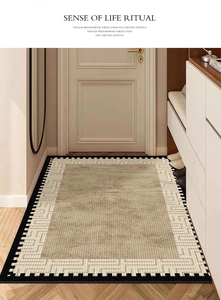 Detail of a brown woven textured doormat with beige geometric borders in an entryway