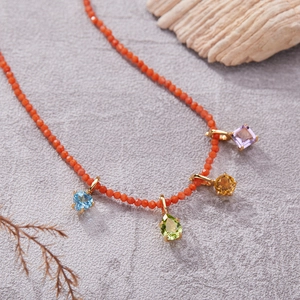 S925 silver beaded necklace with colorful heart and pear gemstones on textured grey surface