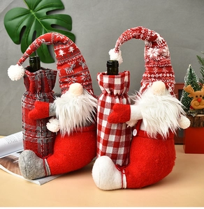 Detail of Christmas gnome wine bottle covers with knitted hats and plaid patterns