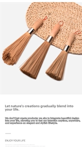Detailed view of bamboo wok brushes with natural wooden handles and red hanging ropes