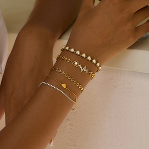 Detailed view of 5pcs layered gold bracelets with hollow heart and zircon accents