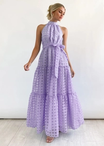Detail of lavender halter dress featuring textured plaid fabric and tiered ruffle hem