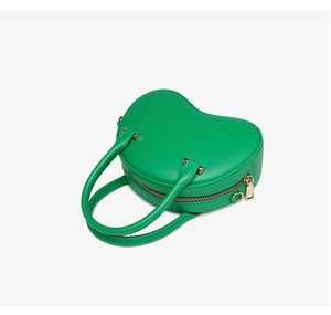 Detailed view of heart-shaped green PVC jelly bag with elegant gold-tone metal hardware