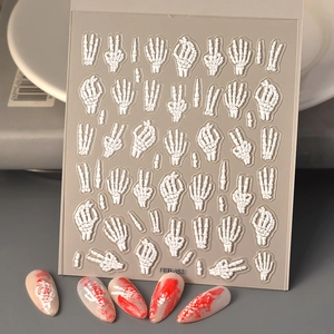 Close-up of 5D white skeleton bone nail decals with embossed texture for Halloween