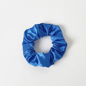 Detailed view of premium blue satin LED hair scrunchie with soft silk texture and luster