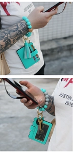 Detailed view of Tiffany blue silicone bead keychain with leather card holder and tassel