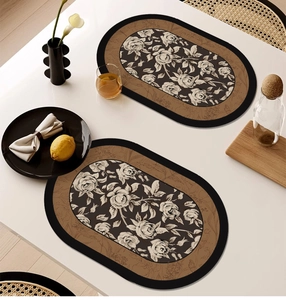 Detailed close-up of oval leather placemat featuring vintage rose floral patterns