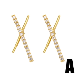 Macro shot of gold-plated X-shape crisscross stud earrings with pavé cubic zirconia
