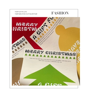 Close-up of Christmas decorative cards and stickers with festive tree and gingerbread designs