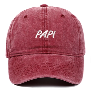 Close-up of embroidered PAPI logo on vintage washed red cotton baseball cap