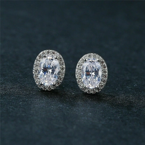 Macro detail of oval halo stud earrings featuring clear zircon and micro-pave setting