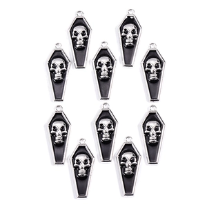 Macro shot of 10 Gothic black and silver vampire skull coffin charms for DIY jewelry making