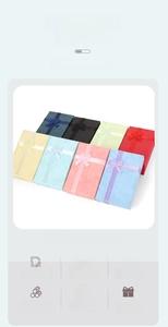 Close-up of multicolored textured jewelry boxes with matching satin ribbon bows and lid