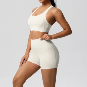 Detail view of white yoga set featuring sports bra and high-waist shorts with side pockets
