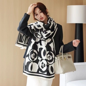 Detailed texture of black and white floral pattern on soft cashmere blend winter scarf