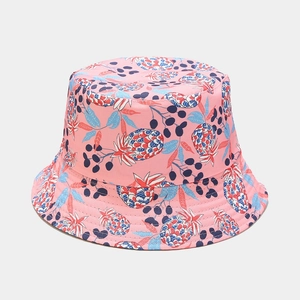 Close-up of pink bucket hat with colorful pineapple patterns and high-quality stitching