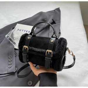 Fashionable black faux fur crossbody bag with leather strap and gold metal buckles for winter