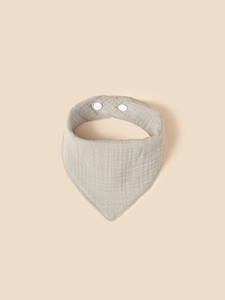 Detail of light grey cotton gauze baby bib featuring soft texture and snap button fasteners