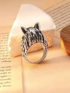 Close-up of vintage wolf head relief ring with detailed metal texture and antique finish