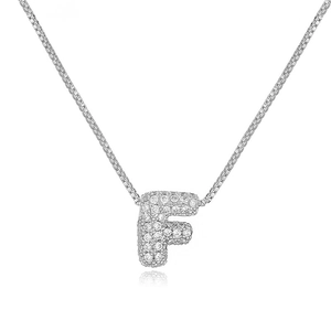 Close-up of silver letter F bubble pendant with cubic zirconia on a thin box chain