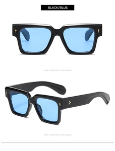 Detail of square black frame sunglasses with blue lenses and gold arrow rivets
