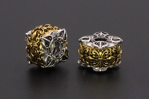 Macro detail of two-tone retro hollow metal bead with vintage pattern for DIY jewelry