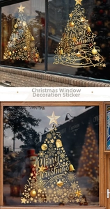 Detail of golden Christmas tree window stickers with festive Merry Christmas lettering