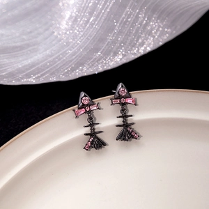 Pink zircon fishbone stud earrings in gunmetal finish displayed on white ceramic
